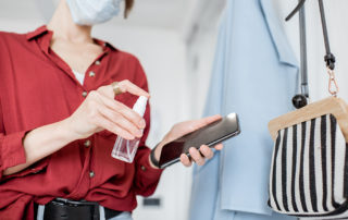 woman disinfecting mobile phone